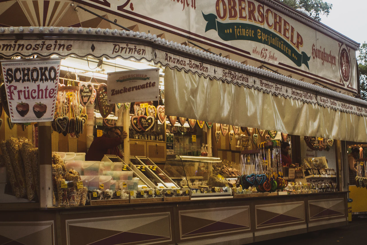 An open kiosko stand with handwritten signs and a counter full of small goods