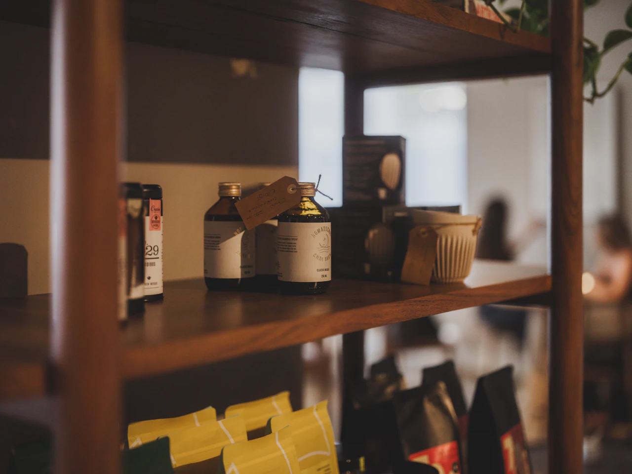 A retail shop owner at the counter reviewing end-of-day paperwork as golden light comes through the window